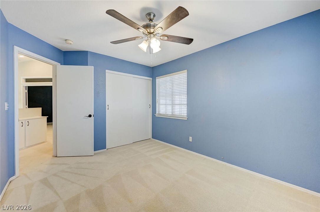 9301 Magic Flower Avenue Las Vegas, NV 89134 - Photo 56 of 70 This inviting bedroom features soft carpeting, a convenient window, and an adjacent bathroom access.