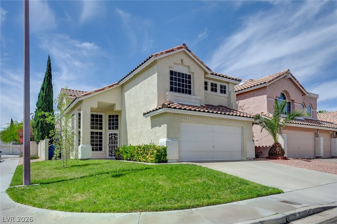 9301 Magic Flower Avenue Las Vegas, NV 89134 - Photo 5 of 70 This charming residence features a well-maintained exterior, attached garage, and a lush green lawn.