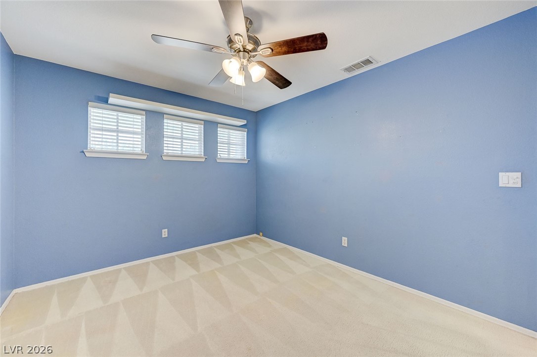 9301 Magic Flower Avenue Las Vegas, NV 89134 - Photo 58 of 70 This bright and airy room features ample natural light and a comfortable, carpeted floor.