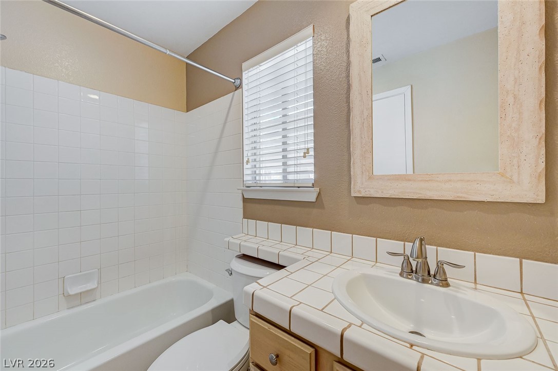 9301 Magic Flower Avenue Las Vegas, NV 89134 - Photo 59 of 70 This bathroom provides functional amenities with a bright and clean aesthetic.