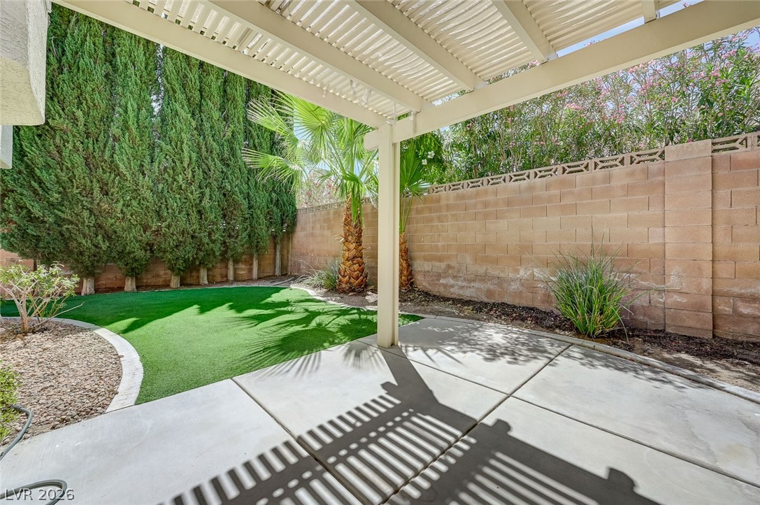 9301 Magic Flower Avenue Las Vegas, NV 89134 - Photo 60 of 70 Enjoy the inviting outdoor living space with a covered patio and lush, low-maintenance landscaping.
