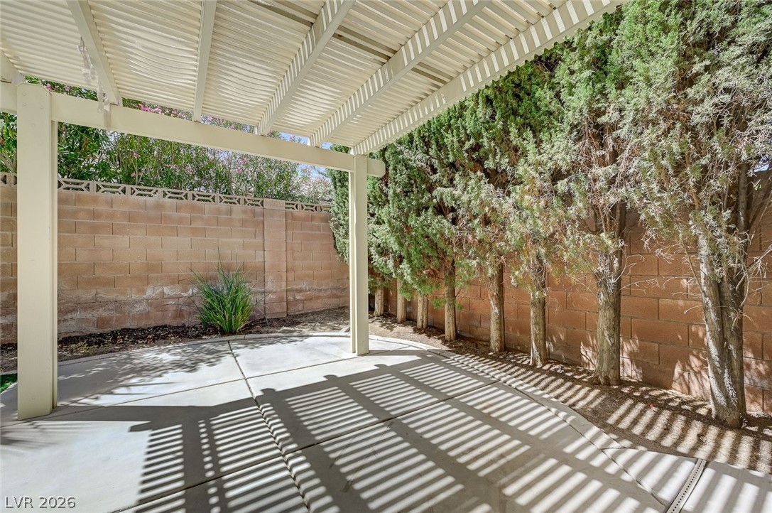 9301 Magic Flower Avenue Las Vegas, NV 89134 - Photo 62 of 70 This private outdoor space features a covered patio area, ideal for relaxation and entertaining.