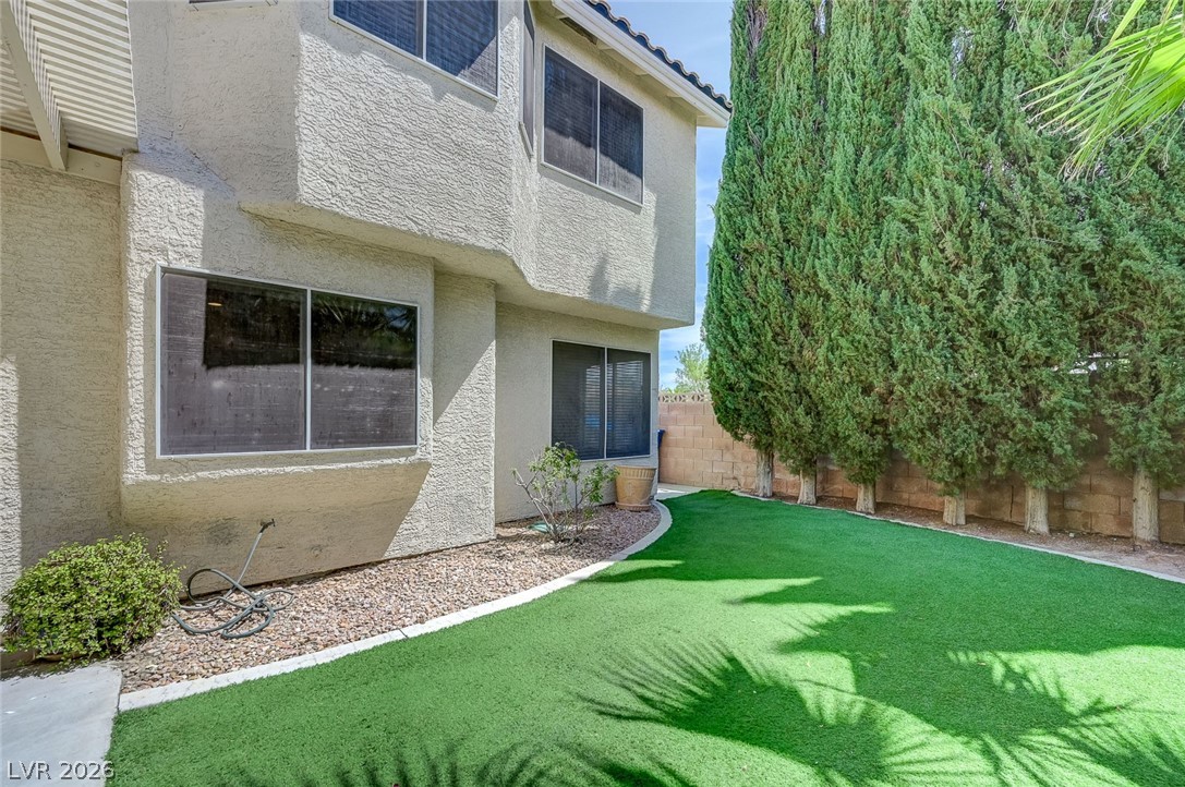 9301 Magic Flower Avenue Las Vegas, NV 89134 - Photo 64 of 70 This residence features a meticulously maintained yard with lush greenery and mature trees.