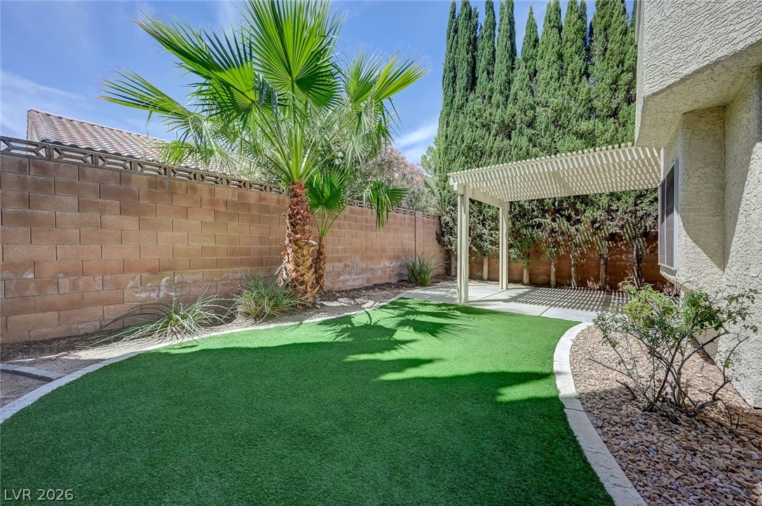 9301 Magic Flower Avenue Las Vegas, NV 89134 - Photo 66 of 70 This outdoor space offers a private yard with a pergola, ideal for relaxation and entertaining.