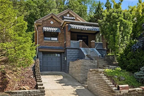 a front view of a house with parking