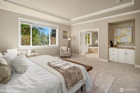 a bedroom with a bed and a large window