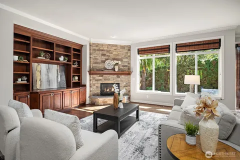 a living room with furniture fireplace and a large window