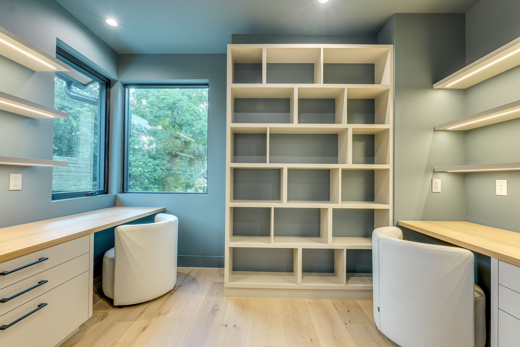 405 Honeycomb Ridge Austin, TX 78746 - Photo 15 of 15 Custom built-in desks and shelving define this bright and efficient home office space.