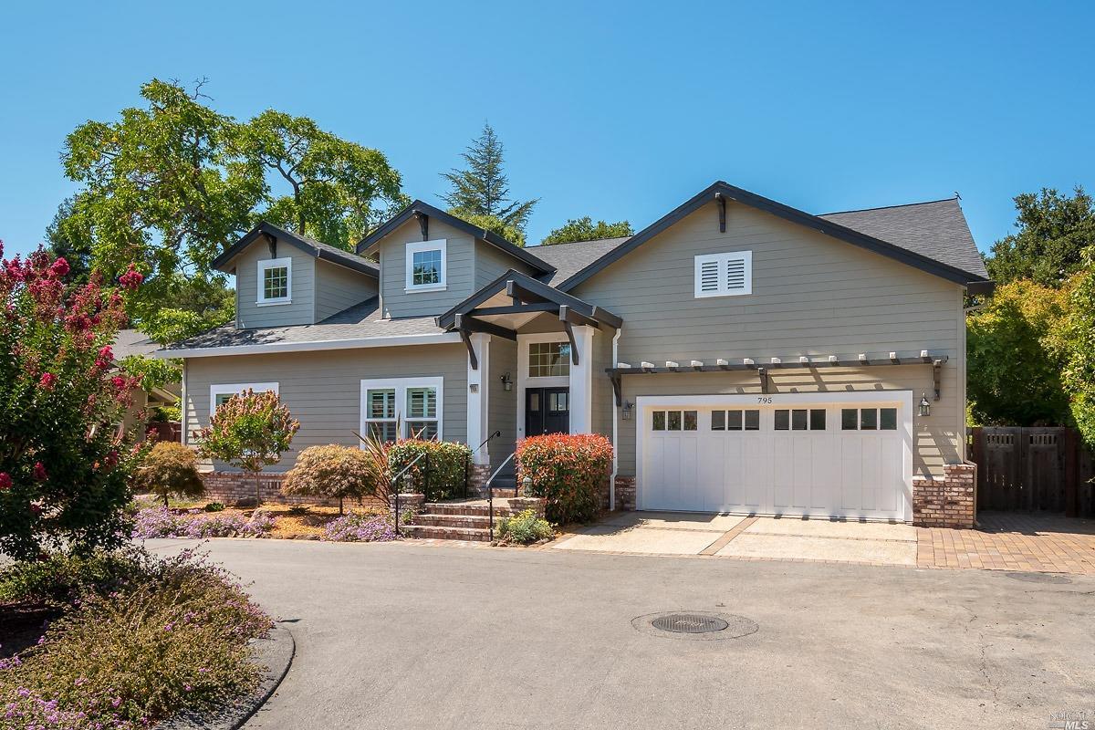 a front view of a house with yard and parking