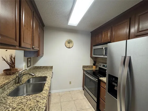 a kitchen with a refrigerator sink and stove