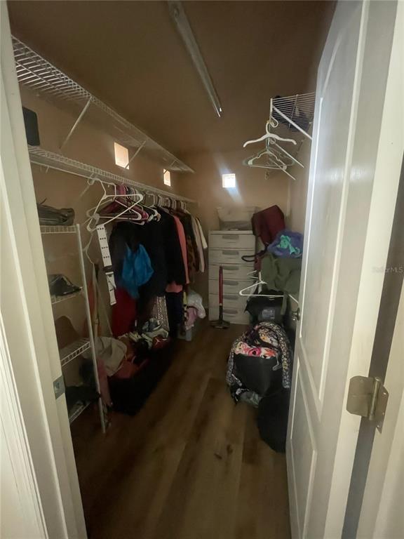 396 Kettering Road Deltona, FL 32725 - Photo 18 of 25 a view of walk in closet with clothes and shoes