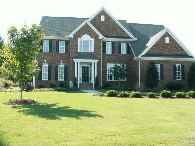 121 Barbee Road Morrisville, NC 27560 - Photo 1 of 6 a front view of a house with a yard