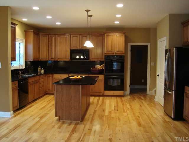 121 Barbee Road Morrisville, NC 27560 - Photo 2 of 6 a kitchen with stainless steel appliances granite countertop a refrigerator a sink and a stove