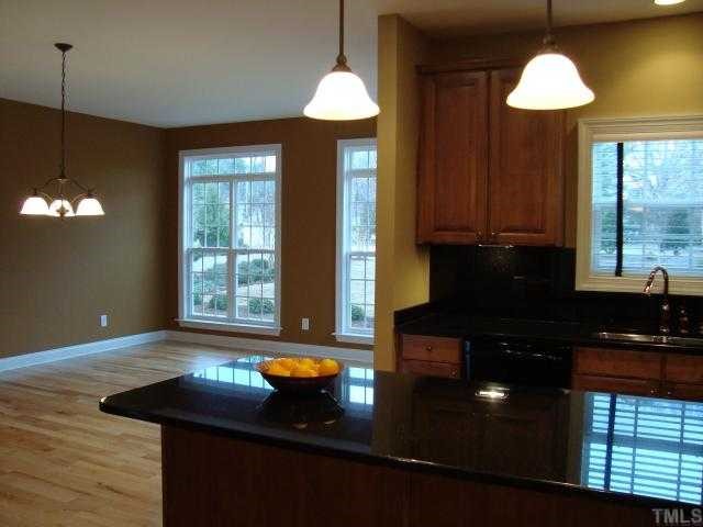 121 Barbee Road Morrisville, NC 27560 - Photo 3 of 6 a kitchen with a sink chandelier and stove