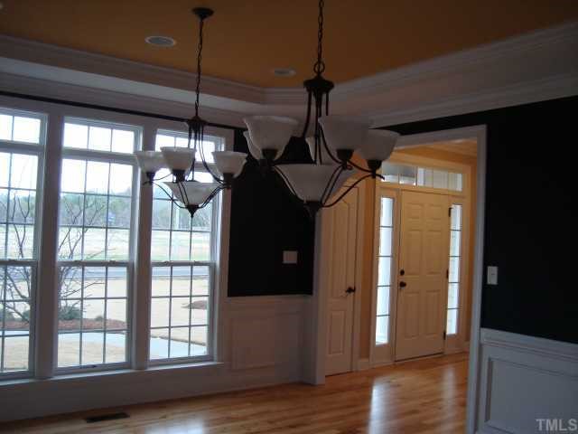 121 Barbee Road Morrisville, NC 27560 - Photo 4 of 6 a view of a hallway with wooden floor and stairs