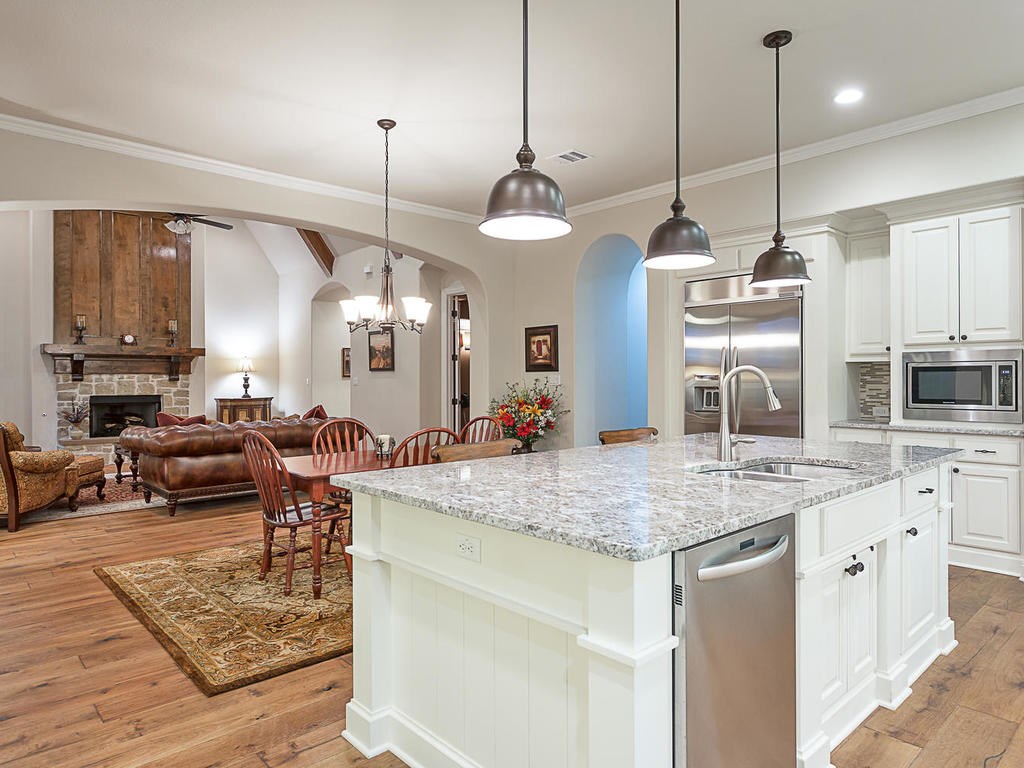 a kitchen with kitchen island a counter top space appliances and cabinets