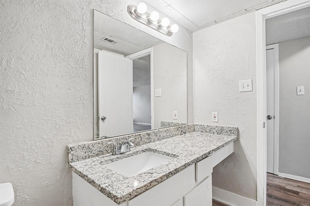 5534 Boca Raton Boulevard, Unit 292 Fort Worth, TX 76112 - Photo 15 of 31 a bathroom with a granite countertop sink and a mirror
