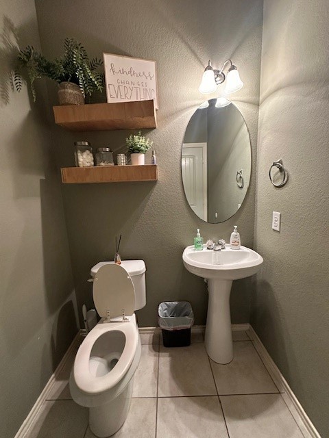 3327 Atherton Ridge Lane Houston, TX 77047 - Photo 11 of 12 a bathroom with a toilet sink and mirror