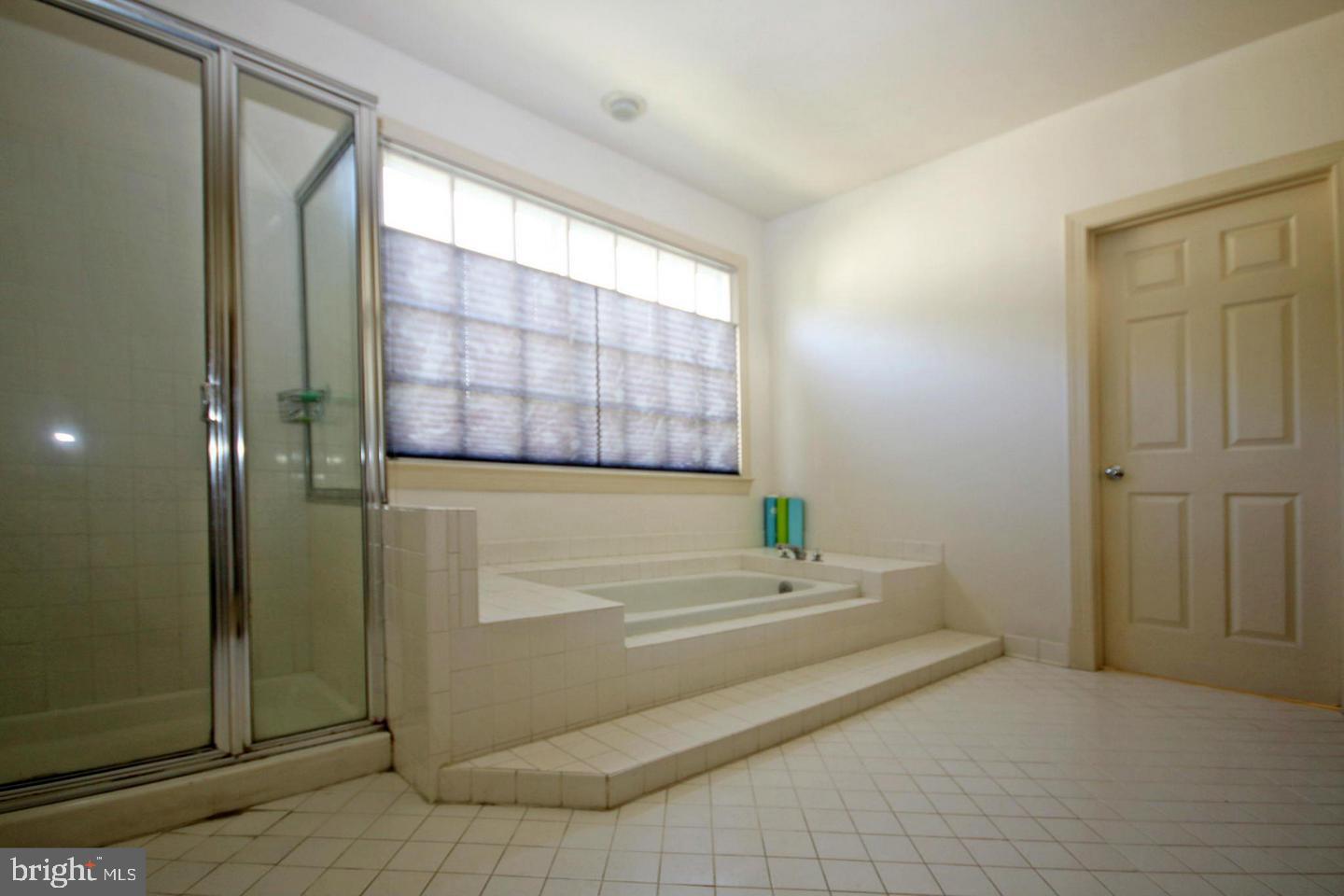 4708 Silverbrook Way Bowie, MD 20720 - Photo 11 of 21 a bathroom with a bathtub and shower