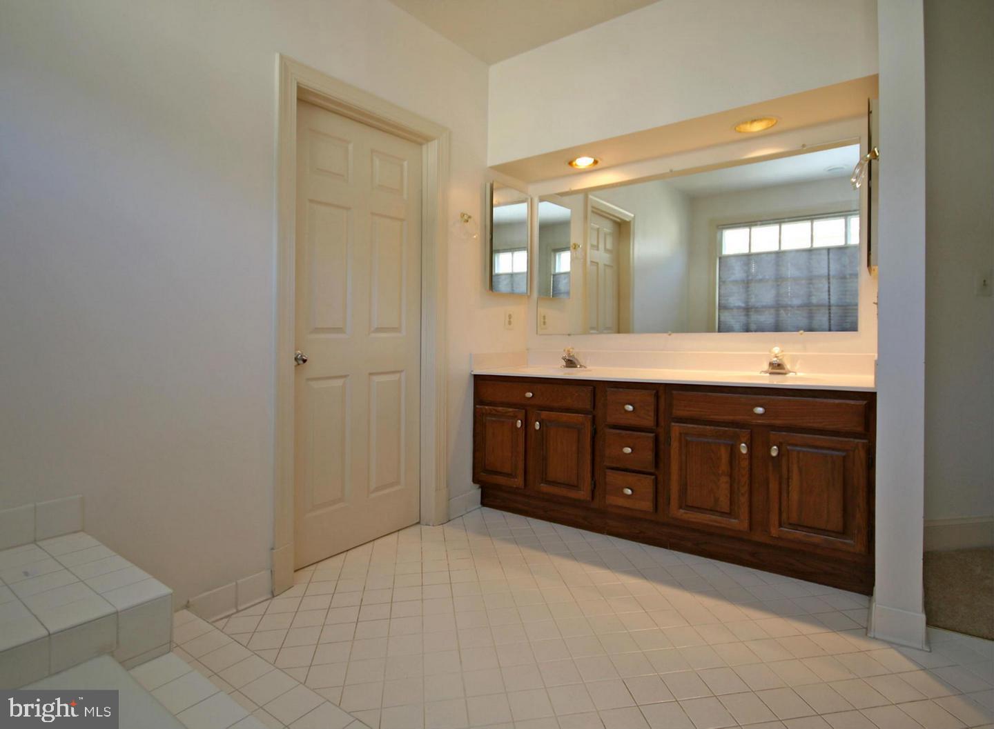 4708 Silverbrook Way Bowie, MD 20720 - Photo 12 of 21 a spacious bathroom with a granite countertop sink mirror and a