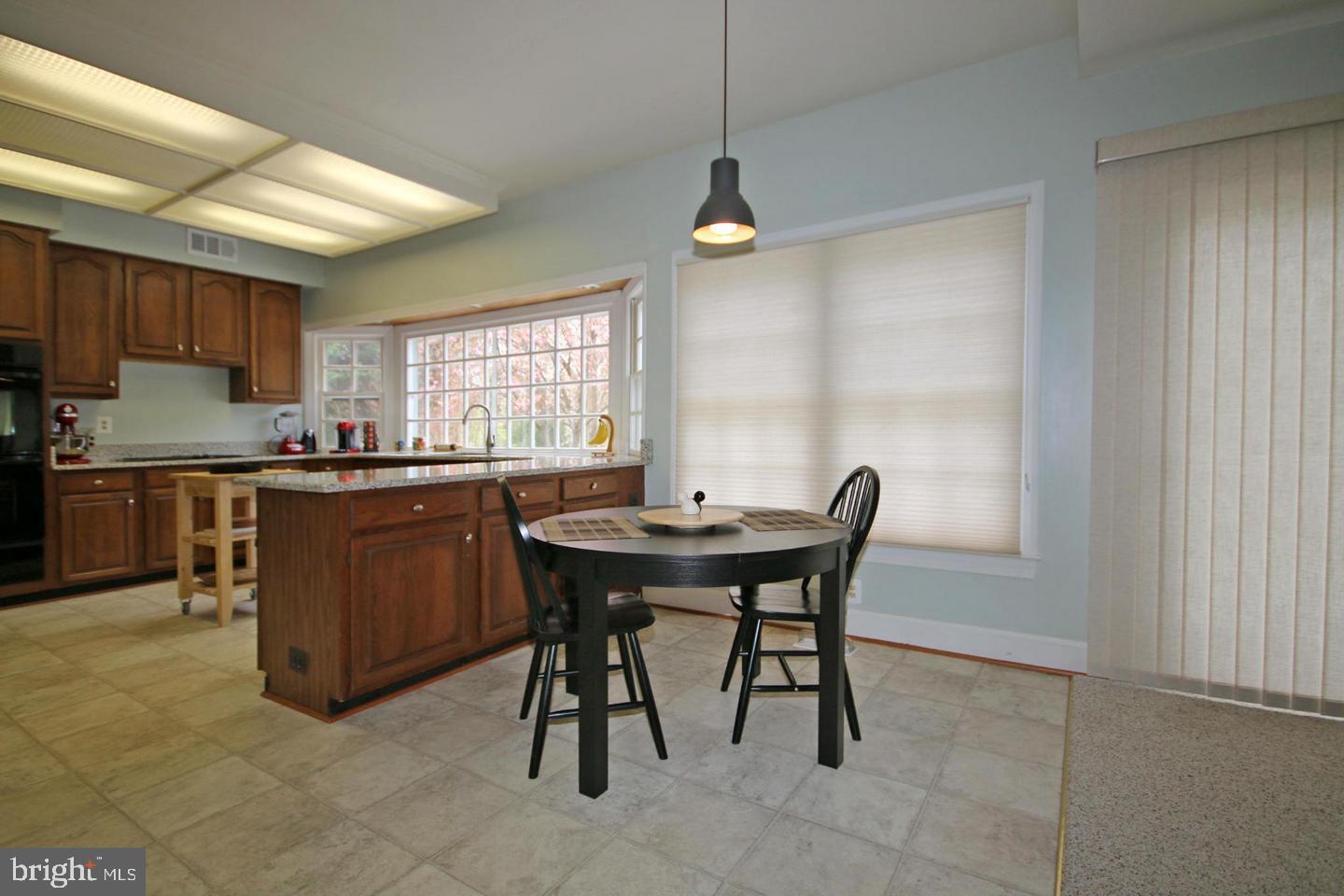 4708 Silverbrook Way Bowie, MD 20720 - Photo 7 of 21 a kitchen with a table and chairs in it
