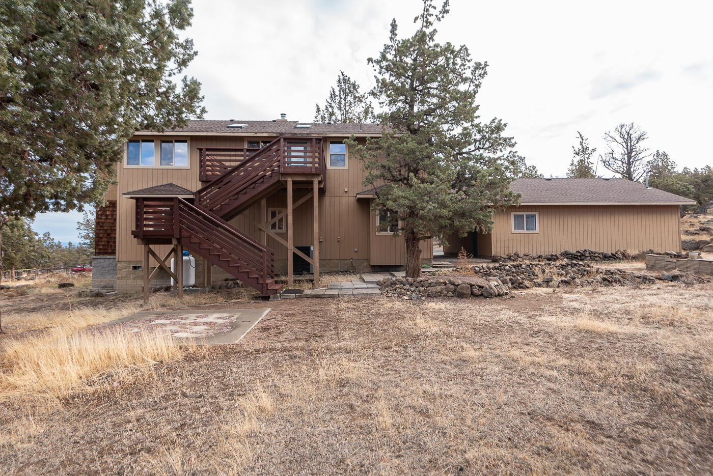 21037 Southwest Gift Road Bend, OR 97703 - Photo 4 of 39 Back of home - large deck off of great room with staircase to yard