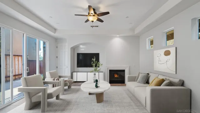 a living room with furniture a fireplace and a flat screen tv