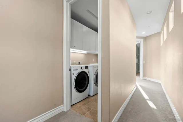 a view of a hallway with washer and dryer