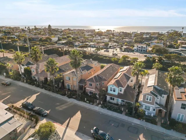 an aerial view of residential houses with city view