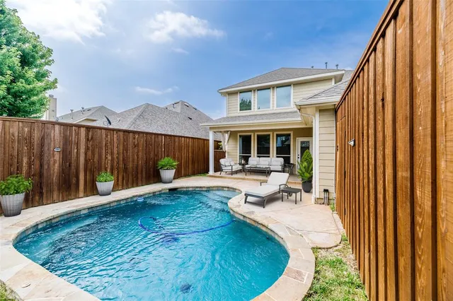 a view of a house with backyard porch and sitting area