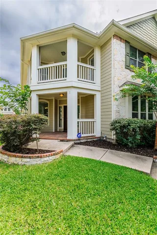 a front view of a house with a yard and porch
