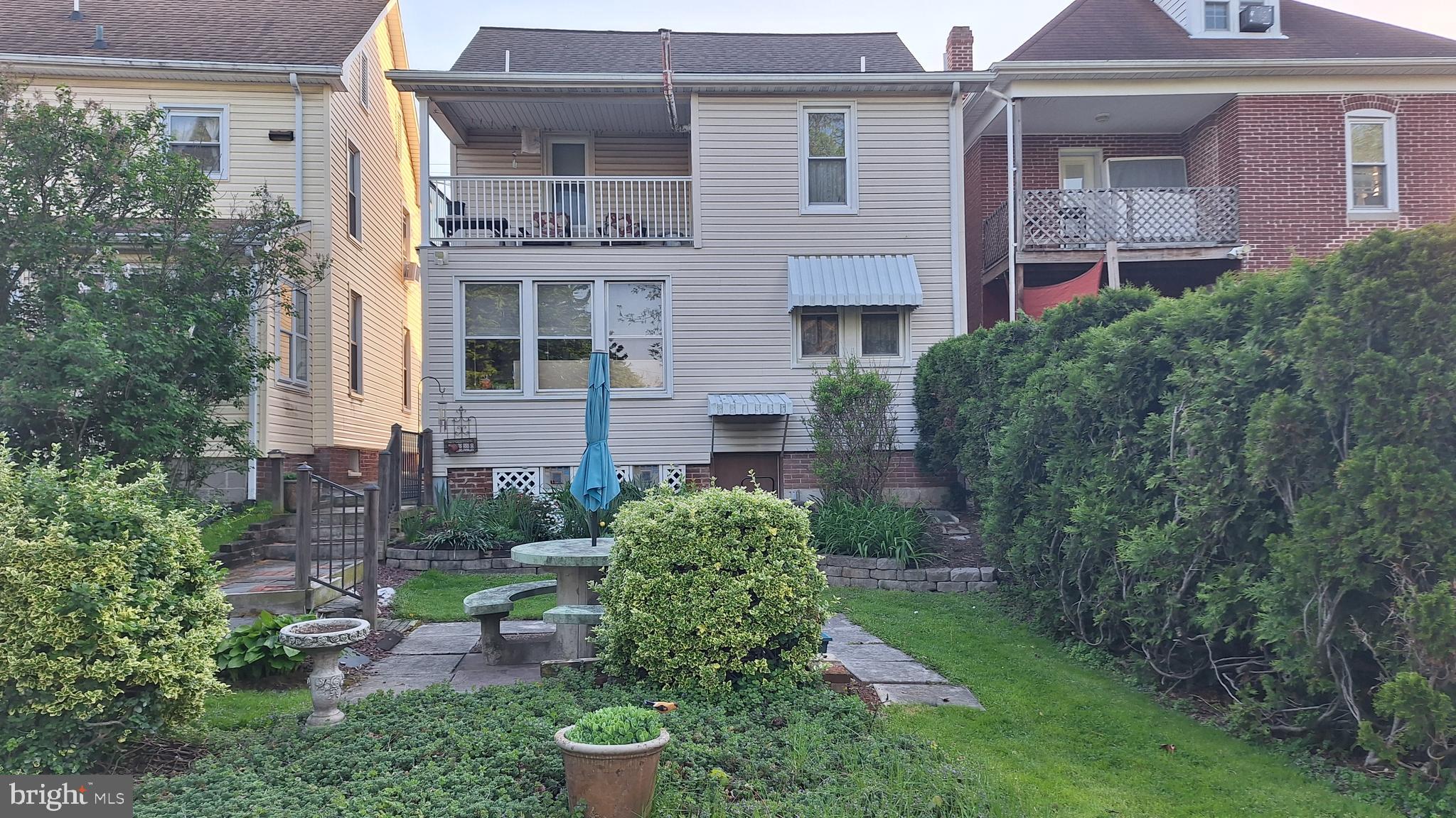 892 Baltimore Street Hanover, PA 17331 - Photo 4 of 6 a view of a brick house with a yard and plants