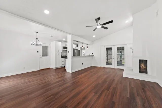 a view of a kitchen with wooden floor and a kitchen