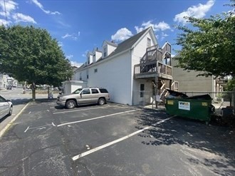 694 Lakeview Avenue, Unit 3 Lowell, MA 01850 - Photo 2 of 19 a view of a car park in front of house