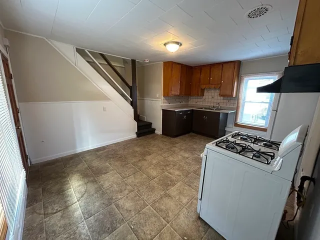 a kitchen with a stove and a refrigerator