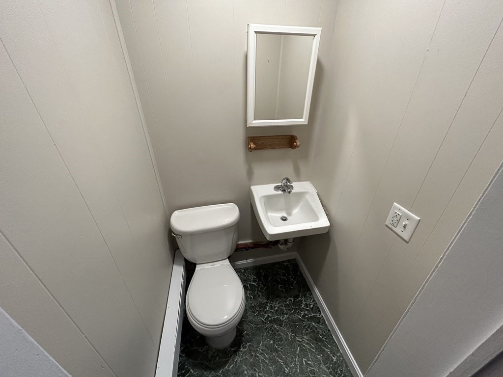 694 Lakeview Avenue, Unit 3 Lowell, MA 01850 - Photo 5 of 19 a bathroom with a sink toilet and a mirror