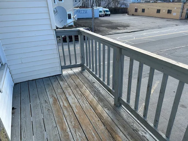 a view of a balcony with wooden floor