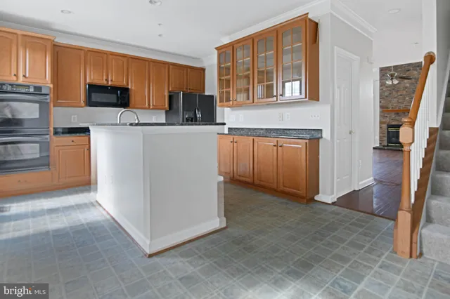 a kitchen with stainless steel appliances granite countertop a refrigerator oven a sink dishwasher and granite countertops