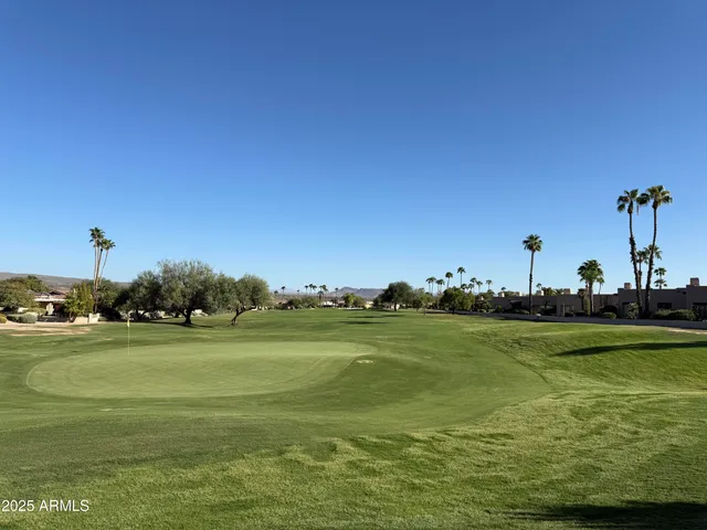 a view of a chairs and table in patio with a yard