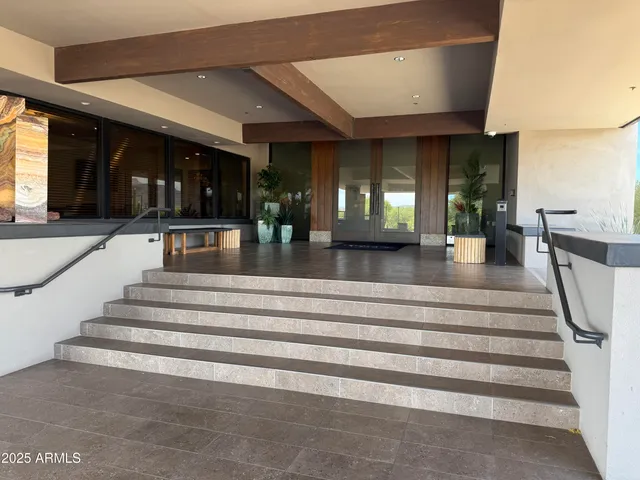 a living room with couches and a dining table with wooden floor