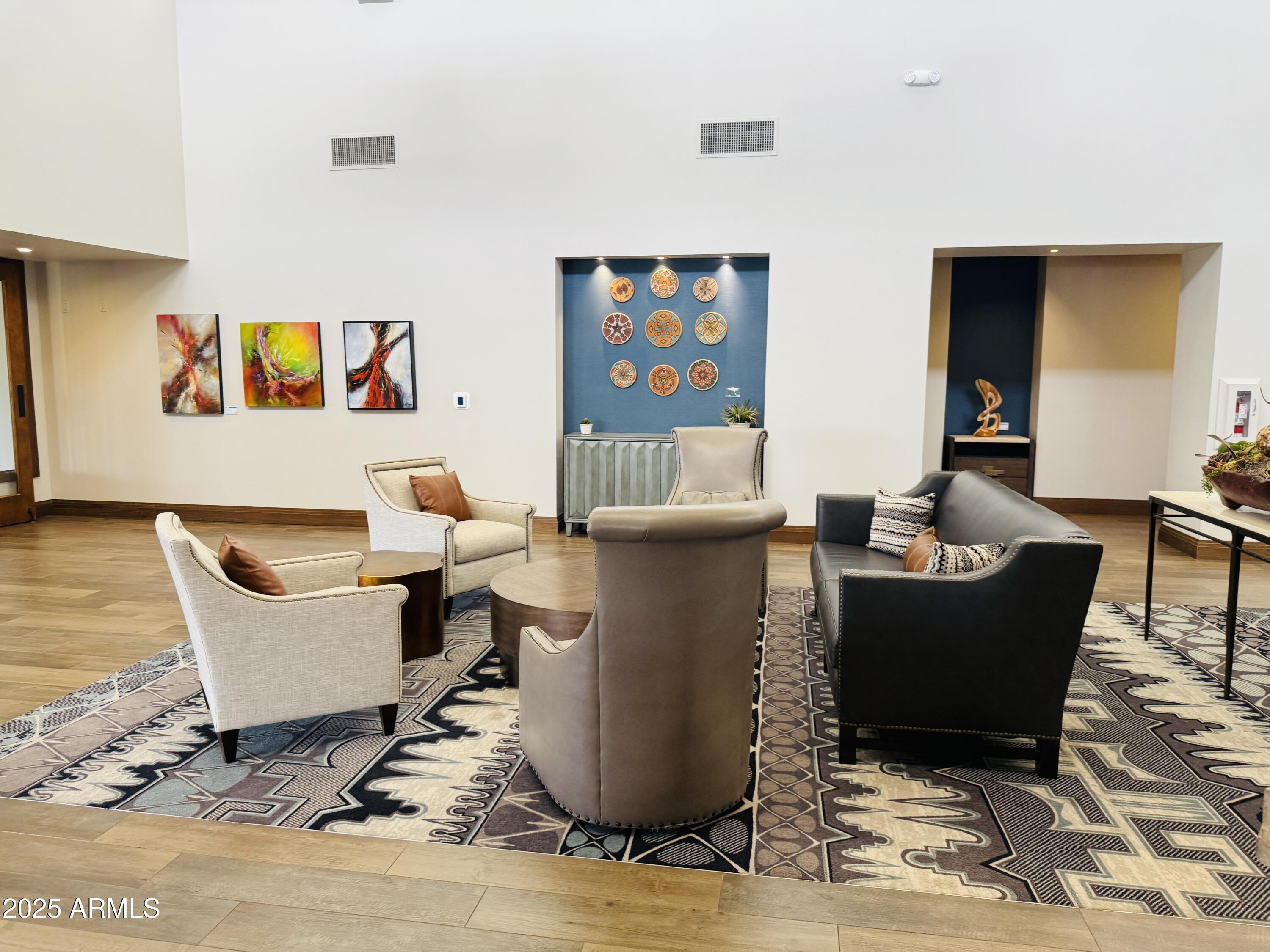 25615 North Bolero Bend, Unit 5 Rio Verde, AZ 85263 - Photo 28 of 65 a living room with couches and a dining table with wooden floor