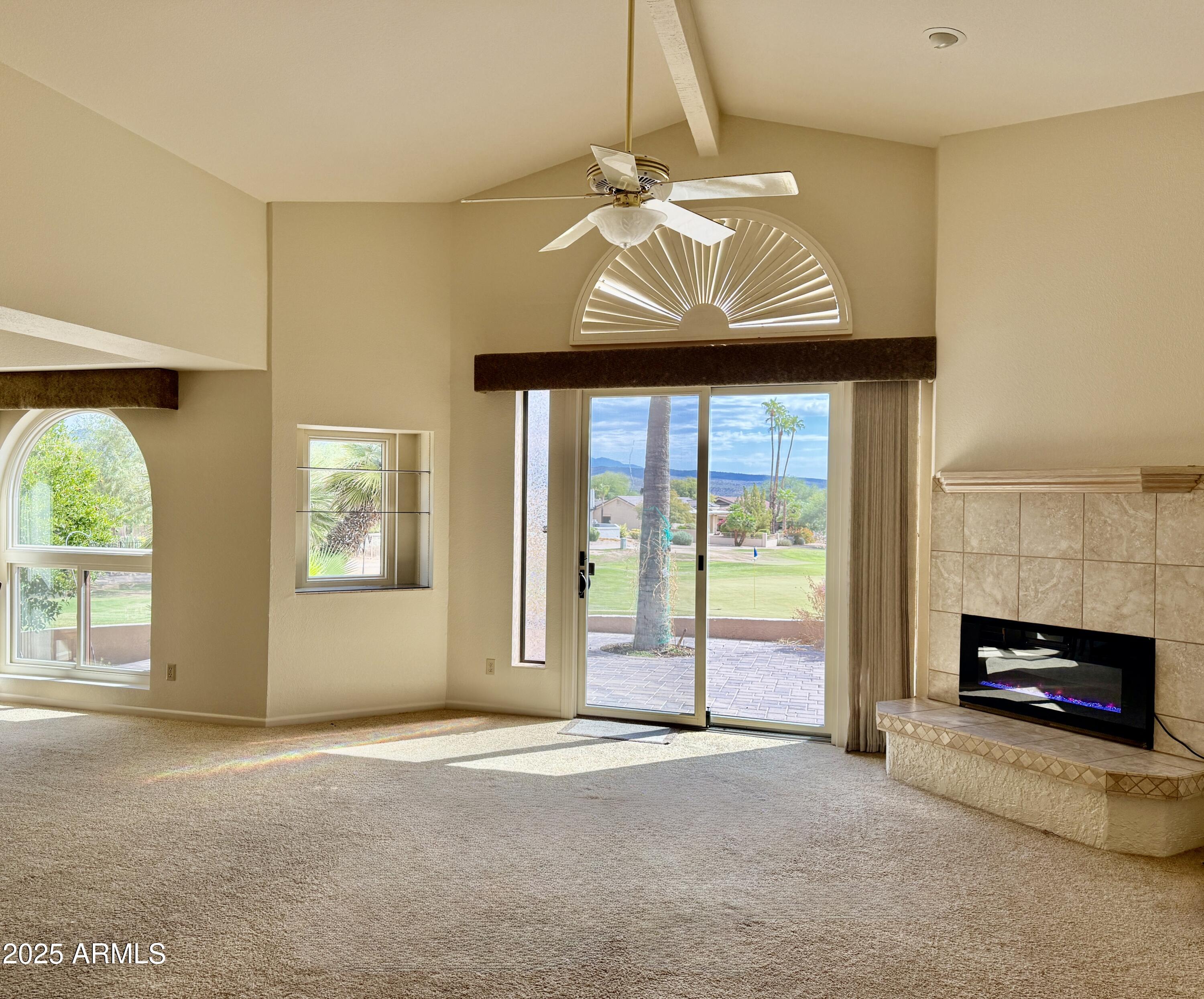 25615 North Bolero Bend, Unit 5 Rio Verde, AZ 85263 - Photo 5 of 65 a view of an empty room with a fireplace and a window