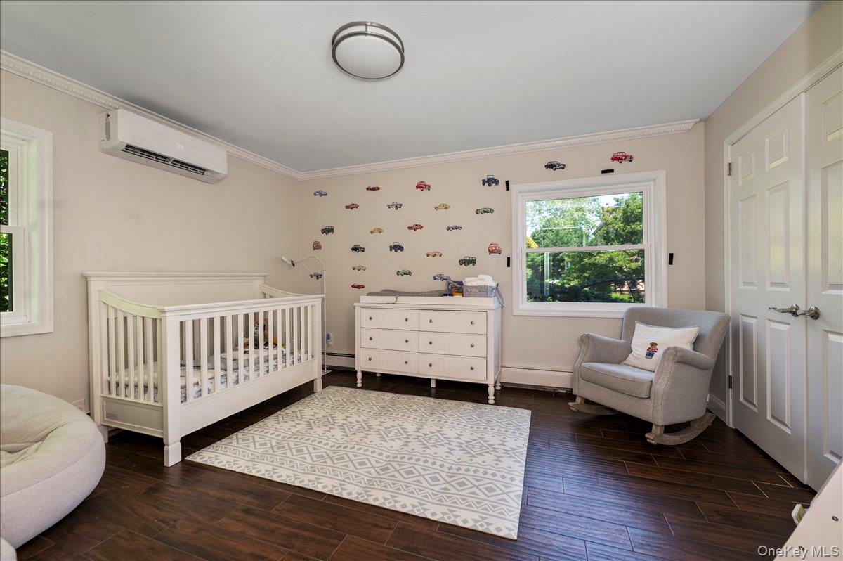 70 Longfellow Road Great Neck, NY 11023 - Photo 21 of 28 a bedroom with furniture and a window