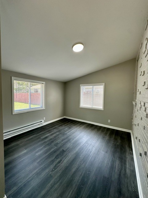 513 Cookane Avenue Elgin, IL 60120 - Photo 11 of 26 an empty room with wooden floor and windows