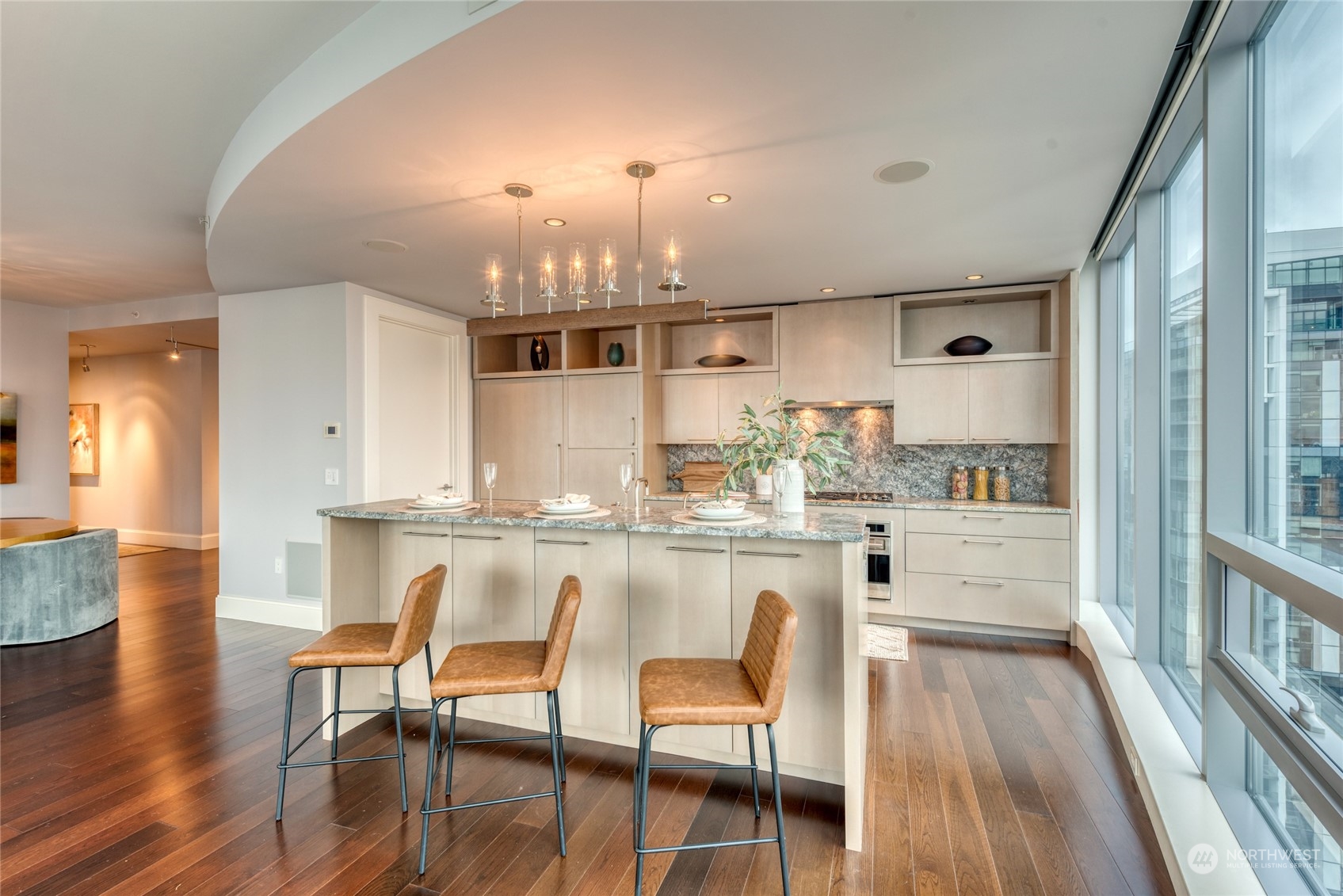 1521 2nd Avenue, Unit 3601 Seattle, WA 98101 - Photo 13 of 39 a kitchen with stainless steel appliances a dining table chairs and wooden floor