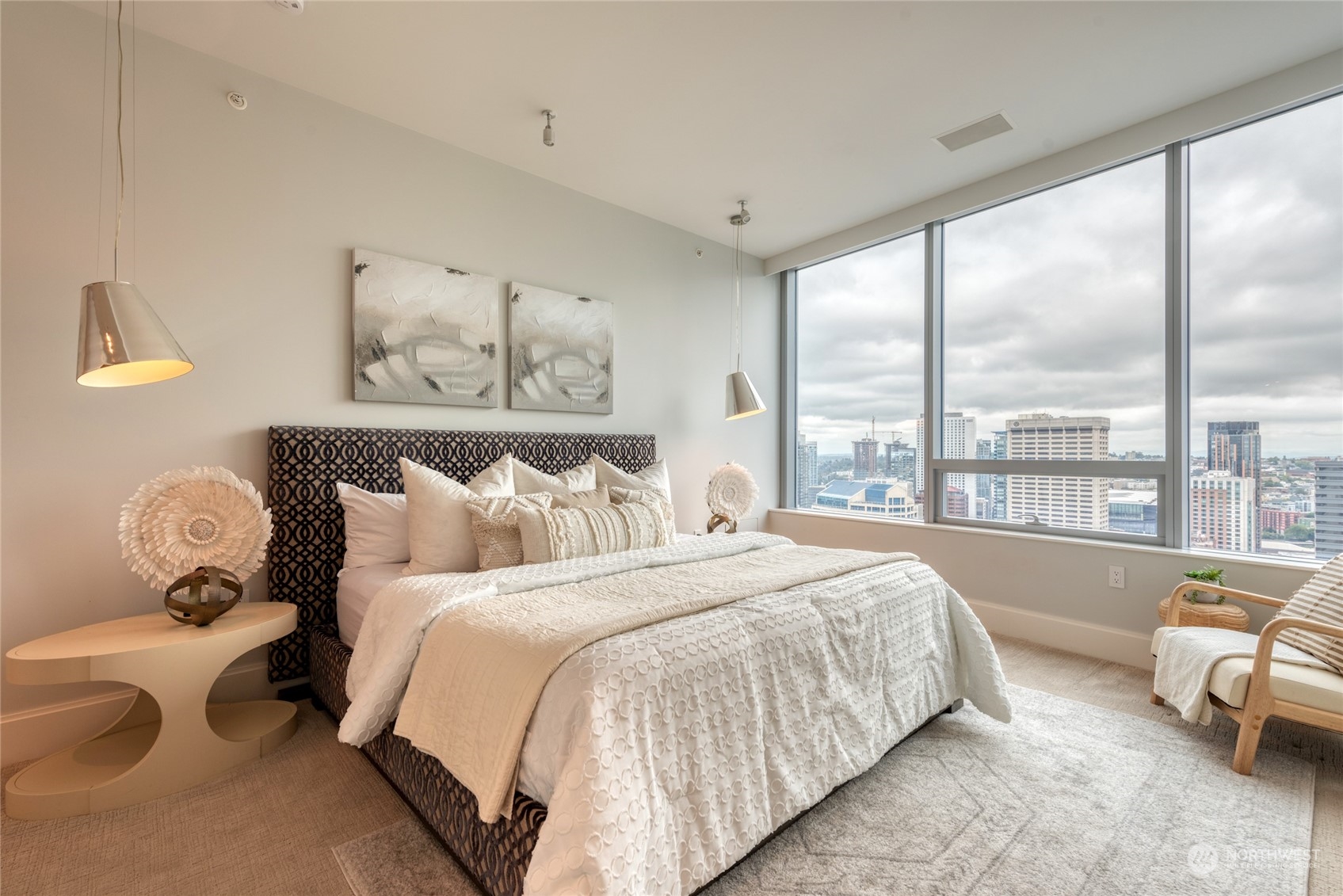 1521 2nd Avenue, Unit 3601 Seattle, WA 98101 - Photo 20 of 39 a bed sitting in a bedroom next to a window