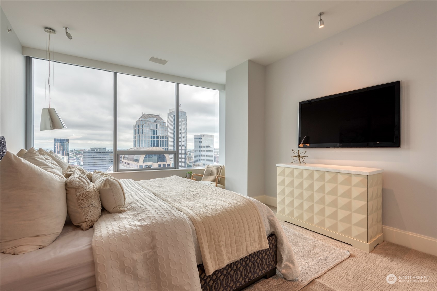 1521 2nd Avenue, Unit 3601 Seattle, WA 98101 - Photo 21 of 39 a bedroom with a bed and a flat screen tv