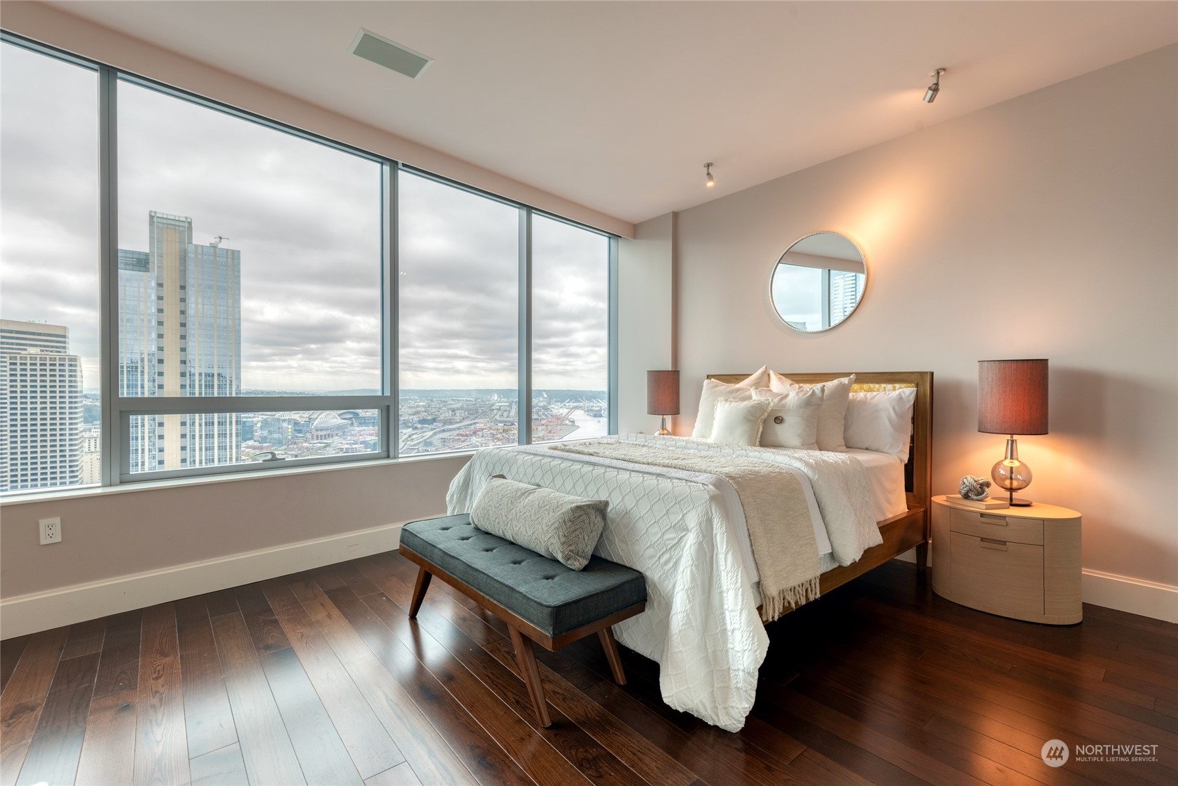 1521 2nd Avenue, Unit 3601 Seattle, WA 98101 - Photo 28 of 39 a bedroom with a bed and wooden floor
