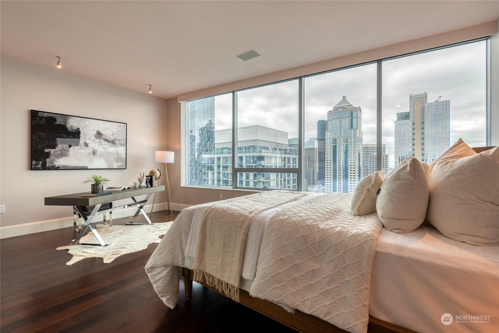 1521 2nd Avenue, Unit 3601 Seattle, WA 98101 - Photo 29 of 39 a bedroom with a bed and glass window