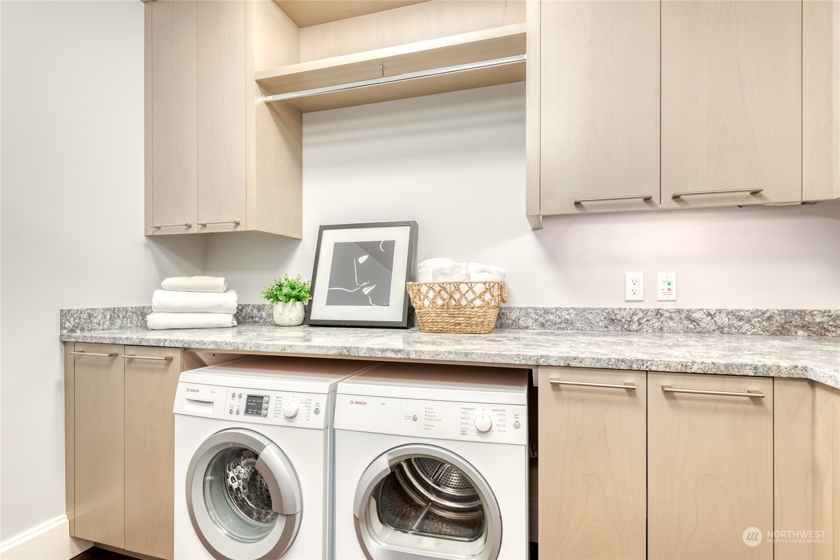 1521 2nd Avenue, Unit 3601 Seattle, WA 98101 - Photo 30 of 39 a utility room with granite countertop cabinets washer and dryer